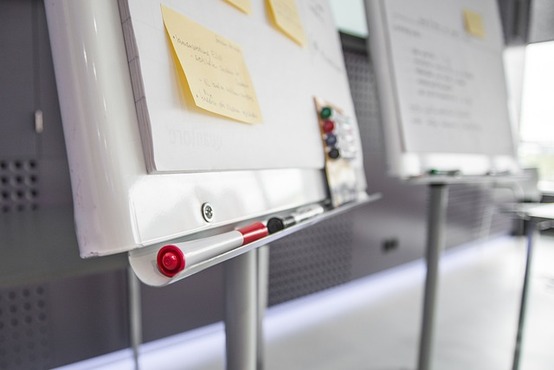 board with post-it notes and pens